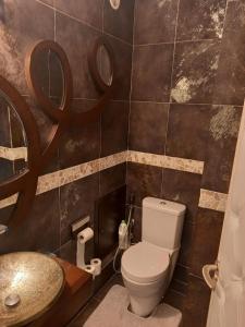 a bathroom with a toilet and a sink at Parisian Sparkle Retreat in Neuilly-sur-Seine