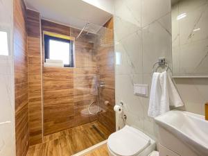 a bathroom with a shower and a toilet and a sink at MaNora in Ulcinj +53 photos