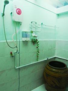 a bathroom with a toilet and a shower in a room at 28 Rachabutr Hostel in Ubon Ratchathani