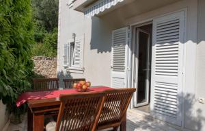 a table with a bowl of fruit on a patio at Apartments Valeria in Korčula