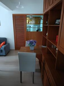 a kitchen with a table and a white chair at Apart hotel Centro Porto Alegre in Porto Alegre