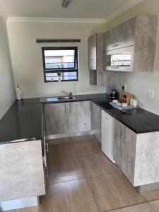 a kitchen with a black counter top in a room at Mafini Villa in Centurion