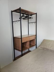 a bedroom with a bed and a wooden shelf at Apart hotel Centro Porto Alegre in Porto Alegre