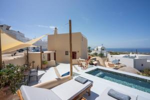 a villa with a swimming pool on top of a house at Casa Terra Vedema Oia - Privacy - Plunge Pool & Panoramic Sunset Terrace in Oia