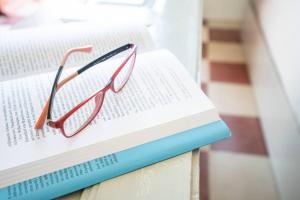 a pair of glasses sitting on top of two books at Casa Terra Vedema Oia - Privacy - Plunge Pool & Panoramic Sunset Terrace in Oia