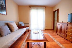 a living room with a couch and a coffee table at CUENCALOFT APARTAMENTOS RURALES FUENTES in Fuentes