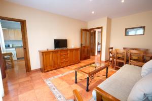 a living room with a couch and a table at CUENCALOFT APARTAMENTOS RURALES FUENTES in Fuentes