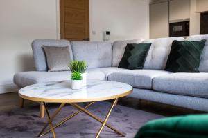 a living room with a couch and a coffee table at Monterey Residence - Stunning, Duplex Apartment in the Heart of Kendal in Kendal
