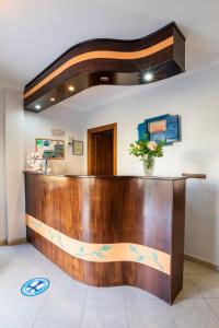 a wooden reception desk in a hospital room at Dilina Studios in Arkasa
