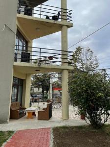 a cat sitting on a balcony of a building at Vila George in Eforie Sud