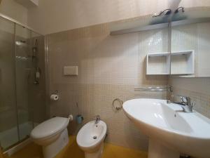 a bathroom with a sink and a toilet at Bed Anthos Porto Cesareo in Porto Cesareo +17 photos