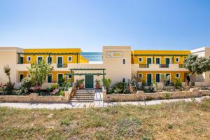 a house with yellow trim and the ocean in the background at Dilina Studios in Arkasa
