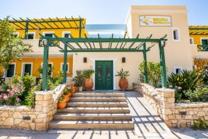 a entrance to a building with a green door at Dilina Studios in Arkasa