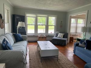 a living room with a couch and a coffee table at Drop Anchor Cottages and Lake House in Geneva-on-the-Lake