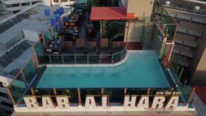 an overhead view of the pool at the bar all haaa hotel at BAB ALHARA HOTEL in Patong Beach