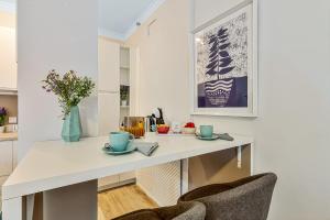 a kitchen with a white table and two chairs at Coral Apartment La Cala Beach in La Cala de Mijas