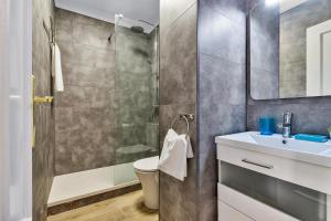 a bathroom with a shower and a toilet and a sink at Coral Apartment La Cala Beach in La Cala de Mijas +8 photos