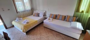 a living room with two beds and a couch at Stella House in Theologos