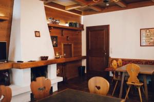 a room with a table and chairs and a dining room at Pension Baranek - Baranek Resorts in Kaprun
