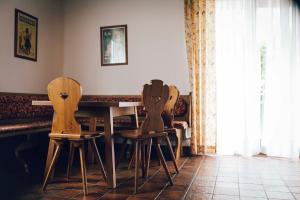 two wooden chairs sitting at a table in a room at Pension Baranek - Baranek Resorts in Kaprun