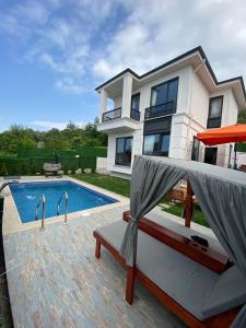 a house with a swimming pool in front of a house at ihlamur konağı Junior villas in Sapanca