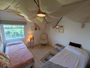 a bedroom with two beds and a window at Large three storey Georgian House and Gardens in Wrentham