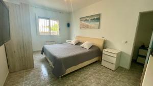 a small bedroom with a bed and a window at MEDDAYS VILLA NOAH in Miami Platja +42 photos