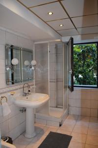 a bathroom with a sink and a shower at EDEN Residence in Skopje