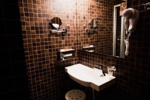 a bathroom with a sink and a mirror at Pension Baranek - Baranek Resorts in Kaprun
