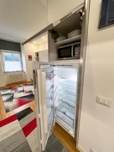 a refrigerator with its door open in a kitchen at NeStop FVG in Tarvisio
