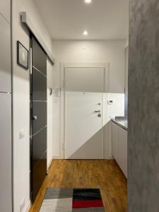 a white bathroom with a shower and a sink at NeStop FVG in Tarvisio +12 photos