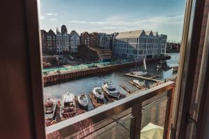 a view from a window of boats in a harbor at Drim Apartaments in Gdańsk