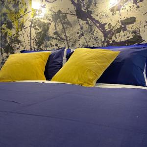 羅馬的住宿－Jovialis - Casa Vacanze，一张黄色和蓝色枕头的床