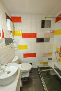 a bathroom with a toilet and a sink and a shower at Sleep Hostel in Niš