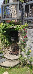 a garden with a stone wall and some flowers at Villa Ola in Barrea +85 photos