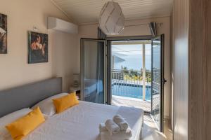 a bedroom with a bed with a view of a balcony at Villa Athina in Angón +37 photos