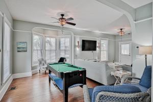 a living room with a pool table in it at Victorian Haven in Saint Augustine