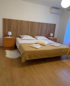 a bedroom with a large bed with two towels on it at Apartment Silvana II in Šibenik