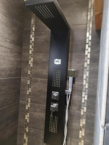 a bathroom with a shower with a shower at La maison du bonheur in Port-en-Bessin-Huppain
