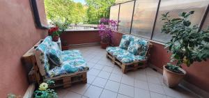 two chairs on a balcony with plants and flowers at Chic 'N Charme Trastevere Terrace 2 in Rome