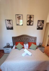 uma cama num quarto com fotografias na parede em Chic 'N Charme Trastevere Terrace 2 em Roma