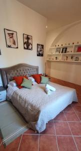 a large bed in a room with some pictures on the wall at Chic 'N Charme Trastevere Terrace 2 in Rome