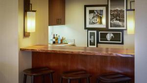 a bar in a hotel room with two stools at Nobu Hotel at Caesars Palace in Las Vegas