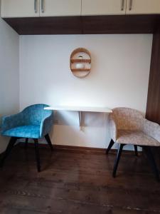 uma sala de jantar com duas cadeiras e uma mesa em Leon em Gornji Milanovac