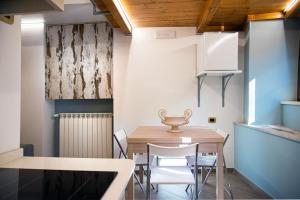 a dining room with a wooden table and chairs at Bed And Breakfast - Lulugiù in Lagonegro