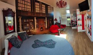 a bedroom with a bed and a living room at Domaine de cyrcé in La Celle