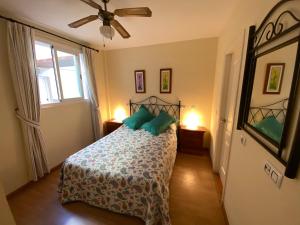 a bedroom with a bed with green pillows on it at Natura World Sea view Vera Playa in Vera