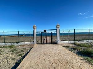 a gate at the beach with the ocean in the background at Natura World Sea view Vera Playa in Vera