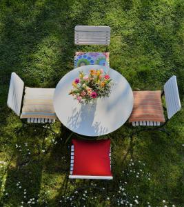 una mesa y sillas con un arreglo floral. en APARTMENT im garten 9, en Gargazzone