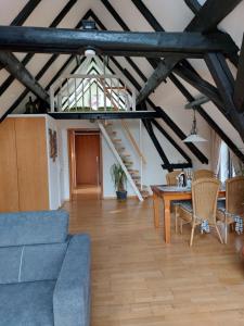 a living room with a blue couch and a table at Haus Schaumburger Land in Volksdorf